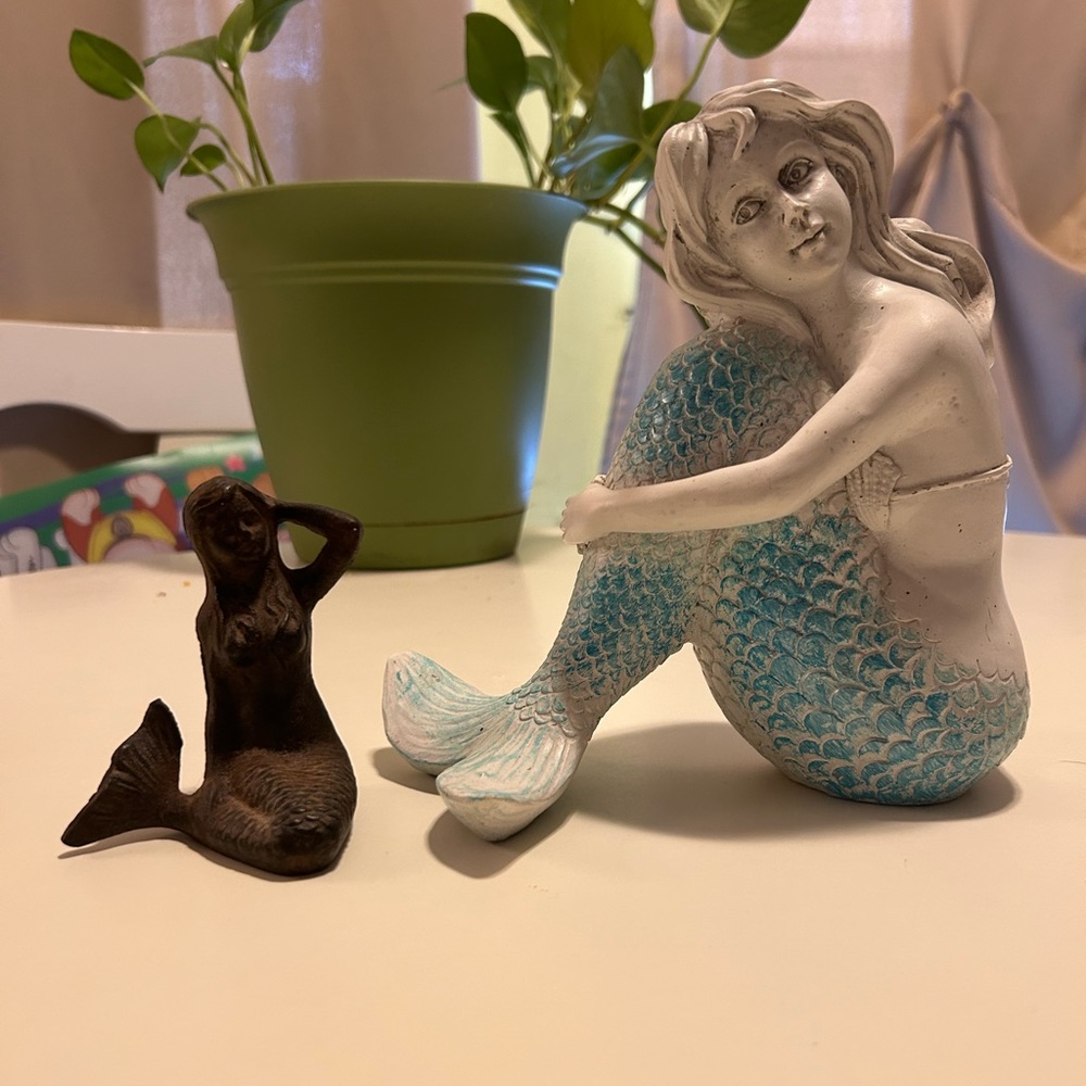 Two mermaid figurines